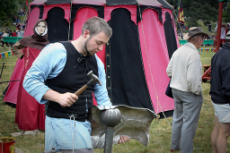 A Blacksmith at work on a chestplate. (671Kb jpeg)