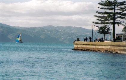 People on the parade watching an incoming Yacht to the marina.